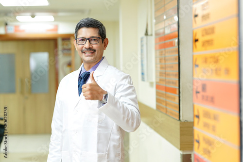 Canvastavla Indian male doctor showing thumps up at hospital.