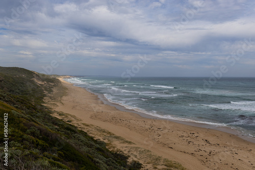 Fototapeta Naklejka Na Ścianę i Meble -  Cloudy day on the empty beach coastline.