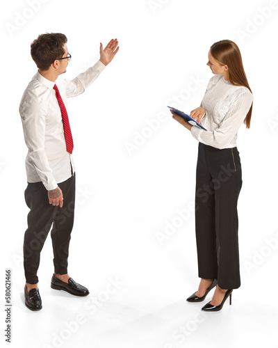 Tapet Two people, man and woman in business style clothes interact with each other isolated over white background