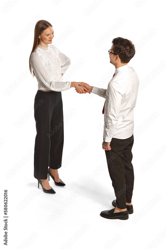 Two people, man and woman in business style clothes interact with each other isolated over white background. Concept of business, office lifestyle, success, career, finance, ad Two people, man and woman in business style clothes interact with each other isolated over white background. Concept of business, office lifestyle, success, career, finance, ad