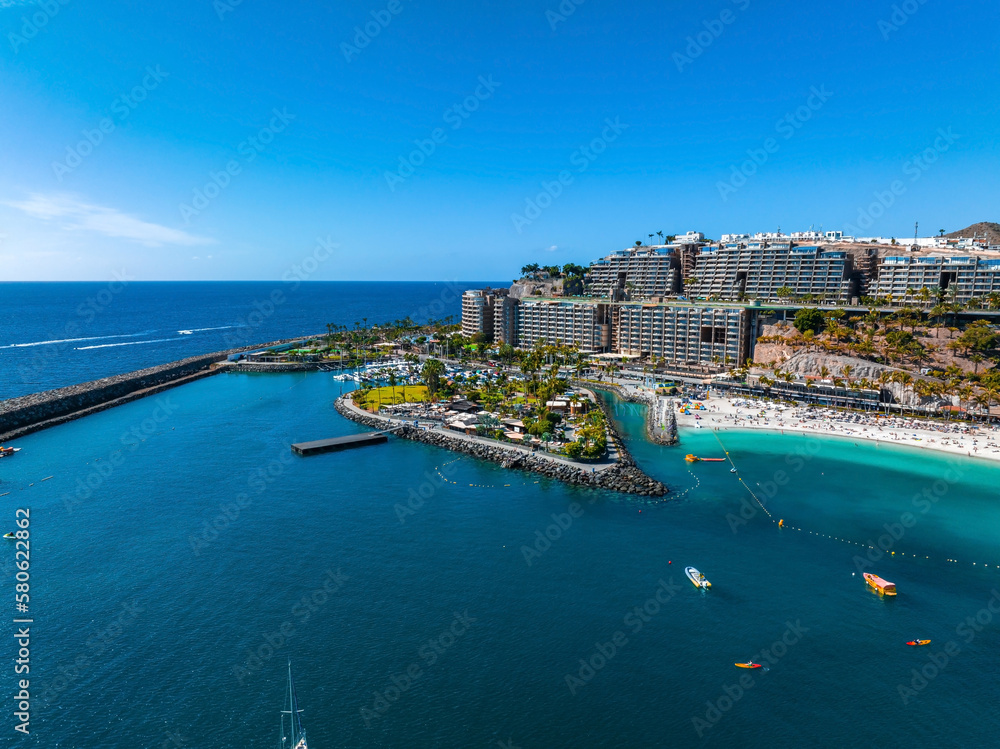 Beautiful aerial landscape with Anfi beach and resort, Gran Canaria, Spain. Luxury hotels, turquoise water, sandy beaches in Spain. Luxury beach vacation concept. Heart shaped island.
