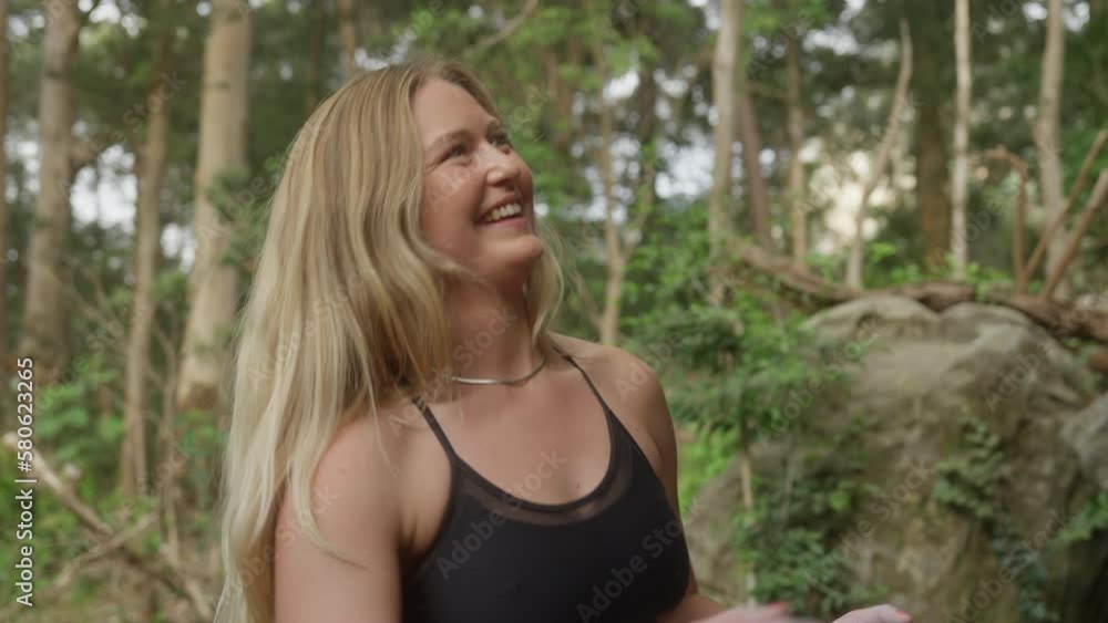 Young Female Rock Climbing Outdoors in the Forest Smiling and Clapping Hands With Chalk Young Female Rock Climbing Outdoors in the Forest Smiling and Clapping Hands With Chalk
