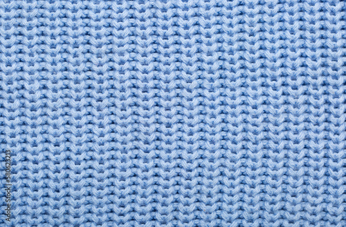 Background of knitted fabric with a pattern. Weaving winter clothes close-up.