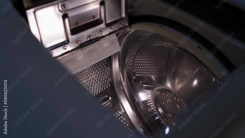The camera flies into a top-loading washing machine The camera flies into a top-loading washing machine