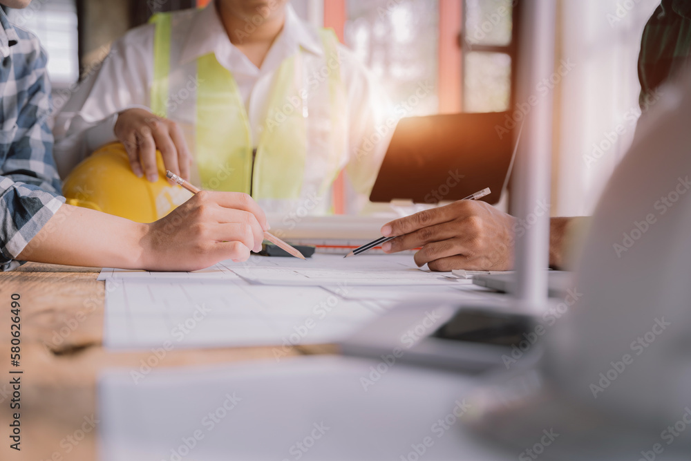Working as a team architect and designer working on blueprint project of new apartments. Photo concept of work on technical drawings in office. Working as a team architect and designer working on blueprint project of new apartments. Photo concept of work on technical drawings in office.