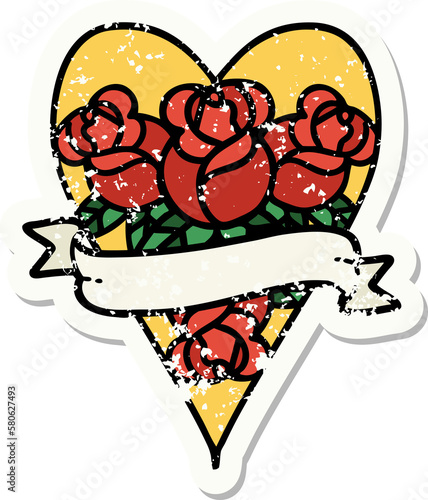 traditional distressed sticker tattoo of a heart and banner with flowers