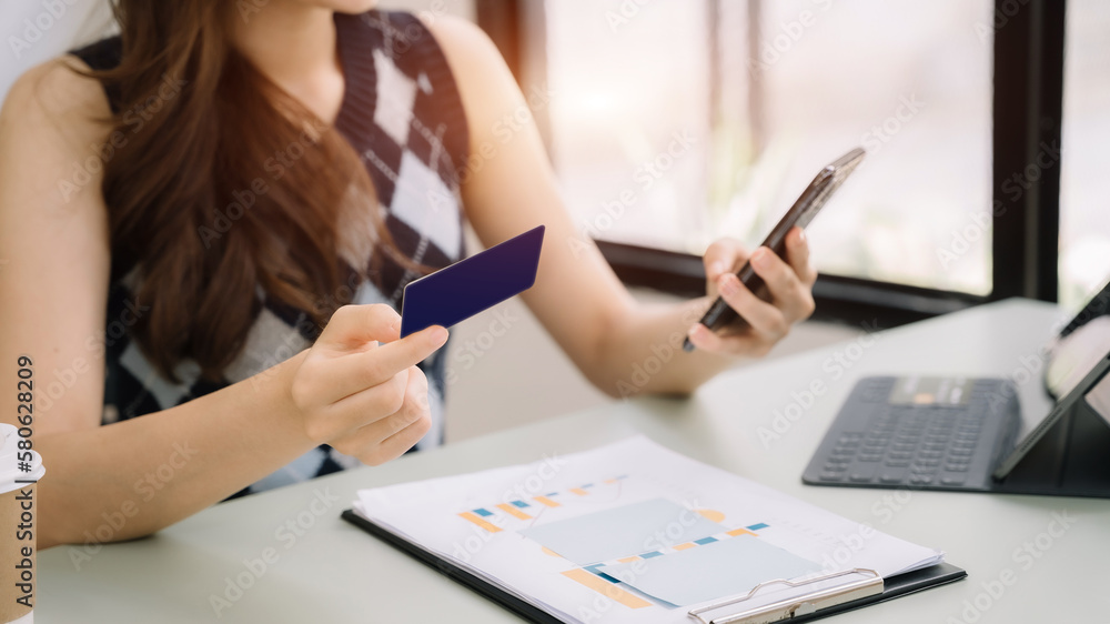 Closeup women holding hand credit card.businessman use smartphone online payments shopping in the morning. Closeup women holding hand credit card.businessman use smartphone online payments shopping in the morning.