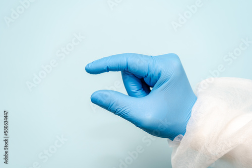 Doctor's hand in blue glove like holding something