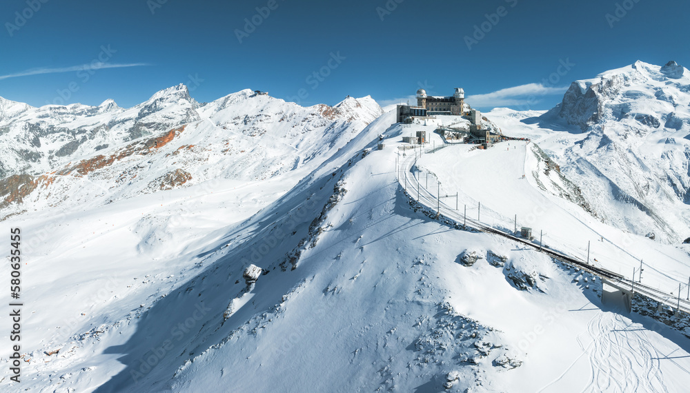 Aerial panorama view of the luxury hotel and the astronomic observatory at the Gornergrat, in the background of the Matterhorn or Cervino mount, Zermatt, Valais, Switzerland, Europe