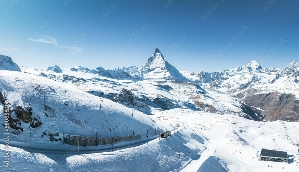Zermatt, Switzerland -The train of Gonergratbahn running to the Gornergrat station and observatory in the famous touristic place with clear view to Matterhorn.