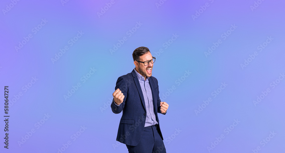 Mid adult elegant business manager screaming cheerfully and pumping fists while celebrating success isolated against blue background Mid adult elegant business manager screaming cheerfully and pumping fists while celebrating success isolated against blue background
