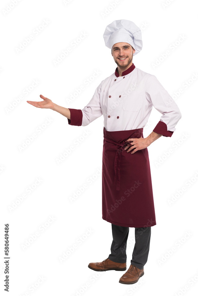 Full length of smiling young cook in uniform standing isolated. Looking camera pointing Full length of smiling young cook in uniform standing isolated. Looking camera pointing