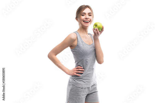 Female fitness model holding apple. Healthy eat and sport concept