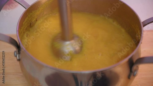 Pumpkin soup preparation, the process of making vegetable cream soup with a blender