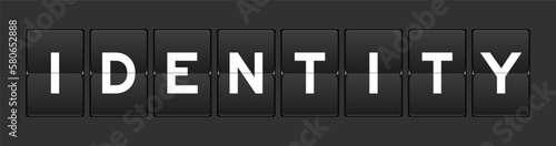 Black color analog flip board with word identity on gray background