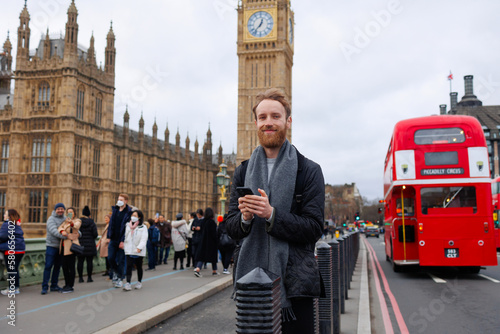 Portrait of a casual man with a smartphone in London