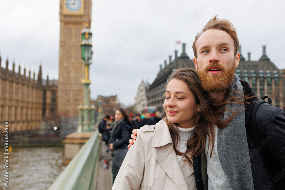 Couple stands in an embrace near Big Ben in London