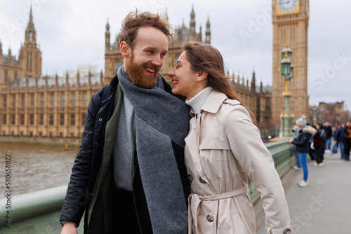 Fototapeta Happy young couple walks holding hands against the background of London's Big Be