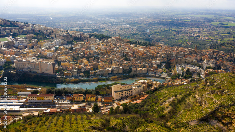 Aerial view on the historic city center of Tivoli, near Rome, Italy. Old Town of Tivoli from above. In foreground Aniene River.