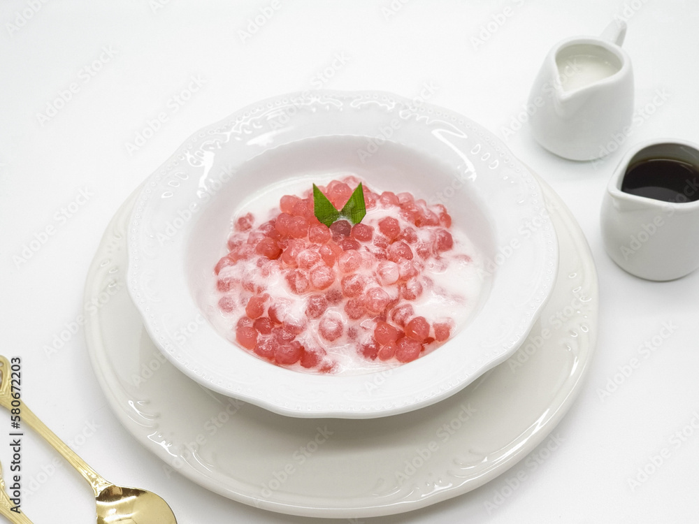 Bubur Sagu Mutiara, Indonesian Dessert Porridge. Made from pearl sago (sagu mutiara), sugar, pandan leaves, and coconut milk. Space for text Bubur Sagu Mutiara, Indonesian Dessert Porridge. Made from pearl sago (sagu mutiara), sugar, pandan leaves, and coconut milk. Space for text