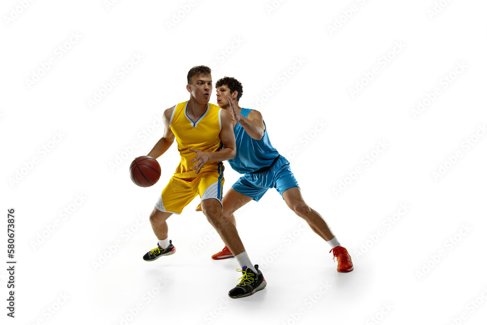 Sports passion. Two male athletes, basketball players in action, motion compete during the game, match.