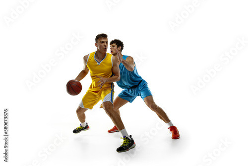 Sports passion. Two male athletes, basketball players in action, motion compete during the game, match.