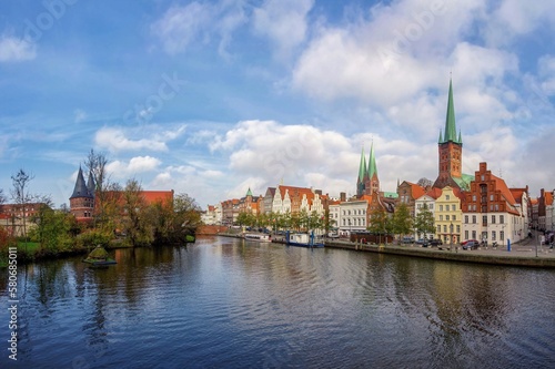 View of the historic city during the bottom with blue sky, clouds and lake. The old Hanseatic city of Lubeck