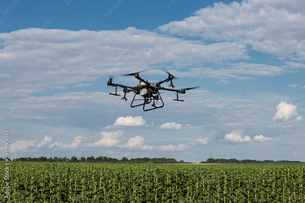Agricultural technology smart farm concept. Farmer technicians remotely fly agricultural drones to fly to spray fertilizer in fields. Agricultural technology smart farm concept. Farmer technicians remotely fly agricultural drones to fly to spray fertilizer in fields.