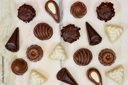 chocolate pieces from various type in box for valentine's day on marble background