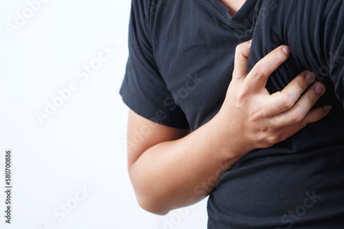 Man having chest pain - heart attack outdoors. or Heavy exercise causes the body to shocks heart disease. © methaphum