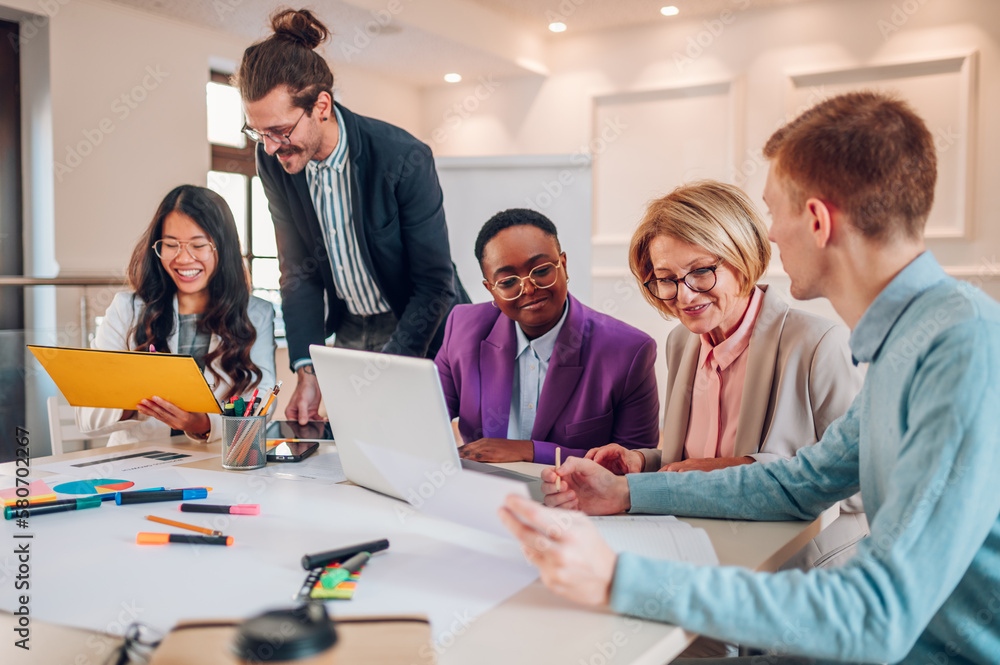 Multiracial business group of people having a meeting in an office Multiracial business group of people having a meeting in an office