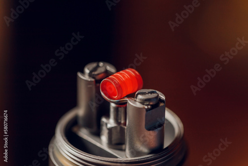 Vaping device with a hot spring on a black background for evaporation. photo