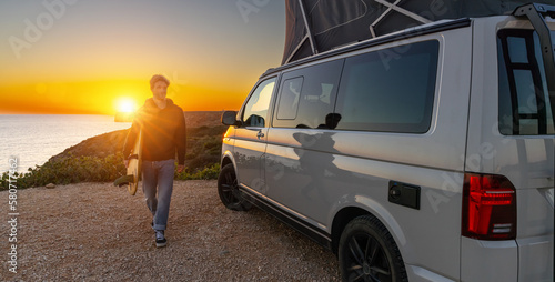 Photography Surfer boy near his mini van and looking on the ocean at summer sunset  with a s