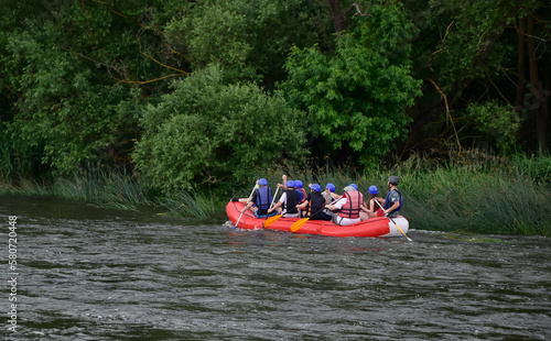 A group of people on the stormy river New Bug. Rafting Ukraine.