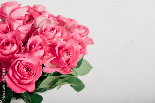 Beautiful bunch of fresh pink roses in full bloom against white background, close up. Bouquet of flowers. Valentine's day or Mother's day card. © Iryna