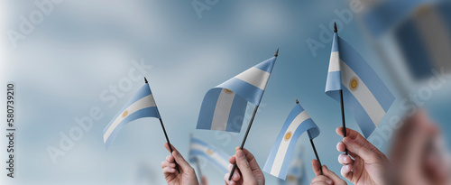 Obraz na płótnie A group of people holding small flags of the Argentina in their hands