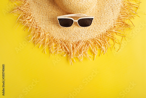 Sunglasses and straw hat on yellow background vacation travel planning mockup