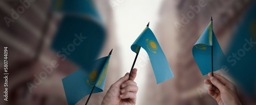 Fototapeta Naklejka Na Ścianę i Meble -  A group of people holding small flags of the Kazakhstan in their hands