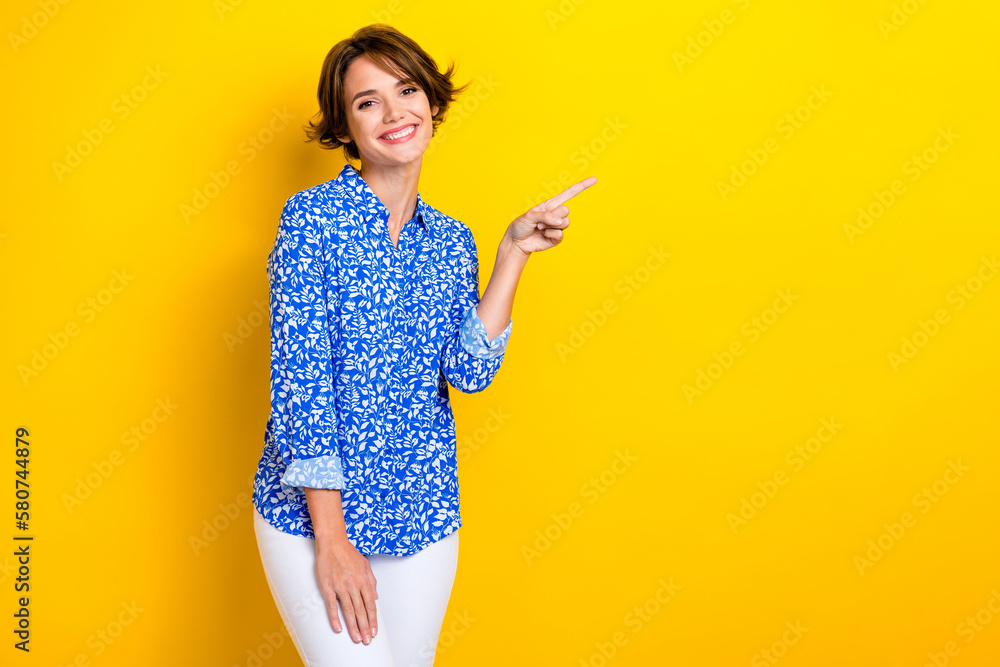 Photo of adorable positive lovely lady arm direct empty space nice feedback quality clothes boutique isolated on yellow color background Photo of adorable positive lovely lady arm direct empty space nice feedback quality clothes boutique isolated on yellow color background