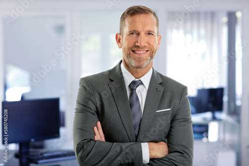 Senior businessman wearing suit and tie while standing at the office