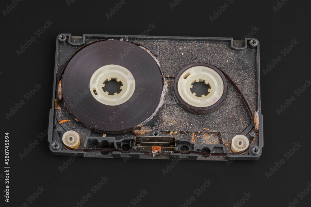 old dirty audio cassette tape on black background