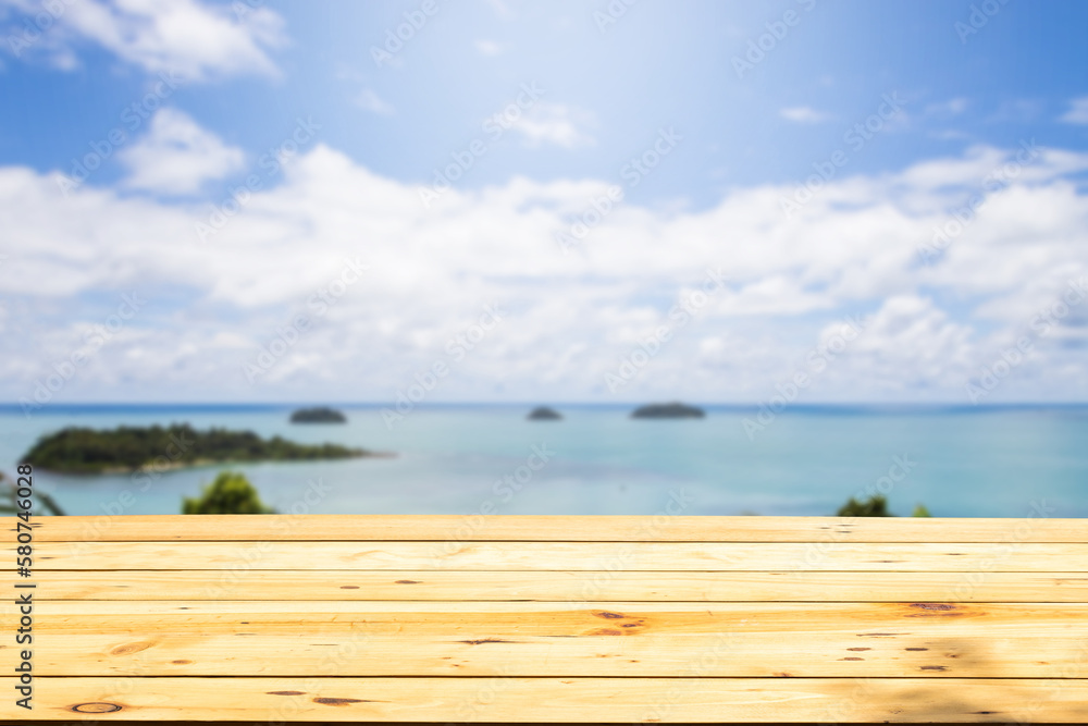 Empty wooden tables by the beach, with a blurred background of the sea, sky and clouds. Empty wooden tables by the beach, with a blurred background of the sea, sky and clouds.