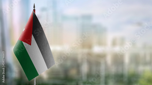 Small flags of the Jordan on an abstract blurry background