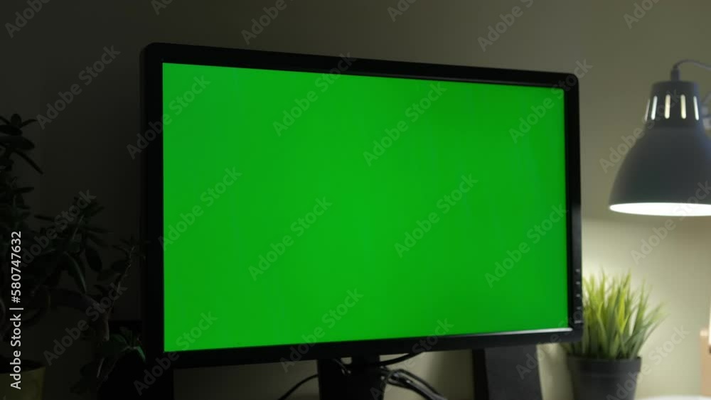 Monitor with green screen. Dark office 4K Monitor with green screen. Dark office 4K