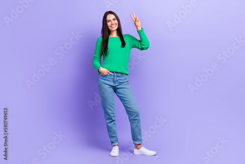 Full body photo of gorgeous lady model showing presenting v sign gesture say hi friends good mood isolated purple color background
