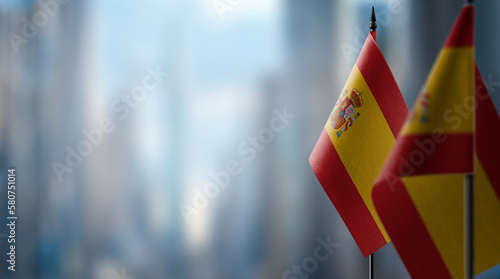 Small flags of the Spain on an abstract blurry background