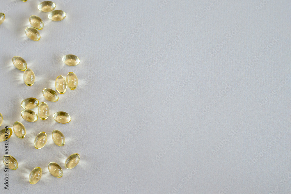 Solar vitamin D3 dietary supplement capsules on beige background, copy space for text, top view Solar vitamin D3 dietary supplement capsules on beige background, copy space for text, top view