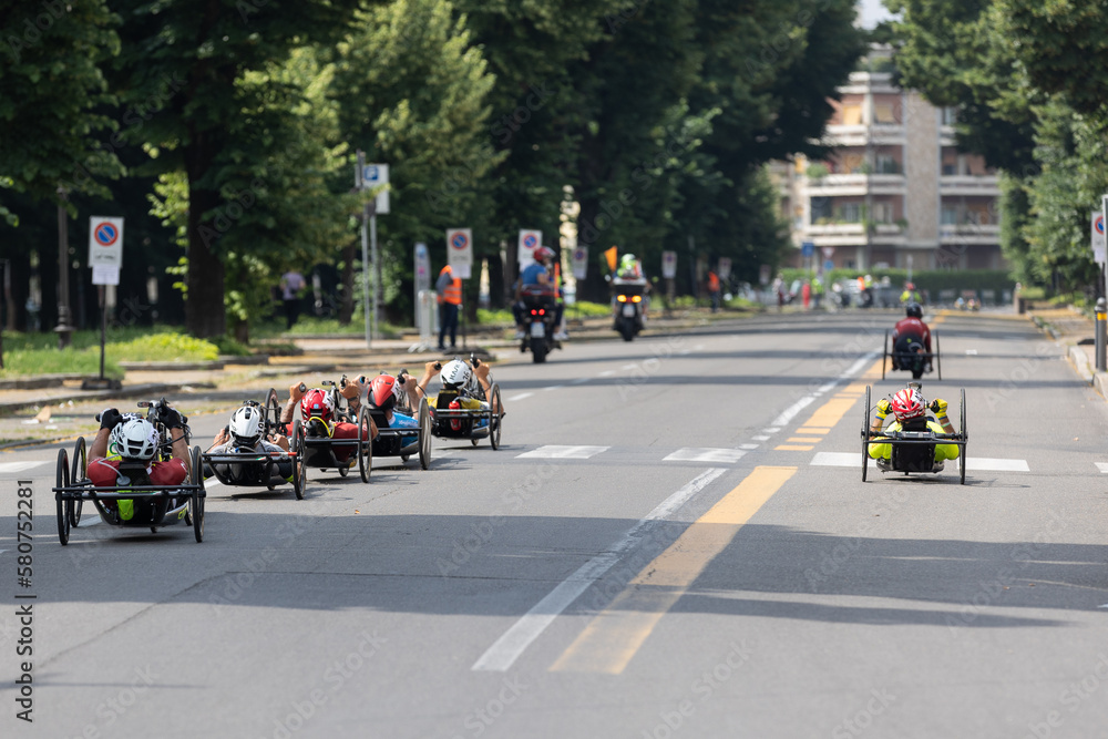 Group of Athletes with Their Special Bikes on a City Track in a Race Group of Athletes with Their Special Bikes on a City Track in a Race