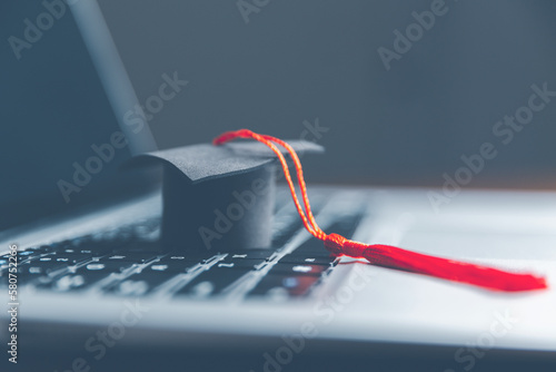 Graduation cap on laptop computer. Concept of global business study, abroad educational, Back to School. Education in Global world, Study abroad business in universities in worldwide. language study
