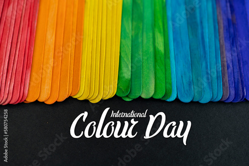 International Colour Day image, Multicolour stick isolated on black background photo